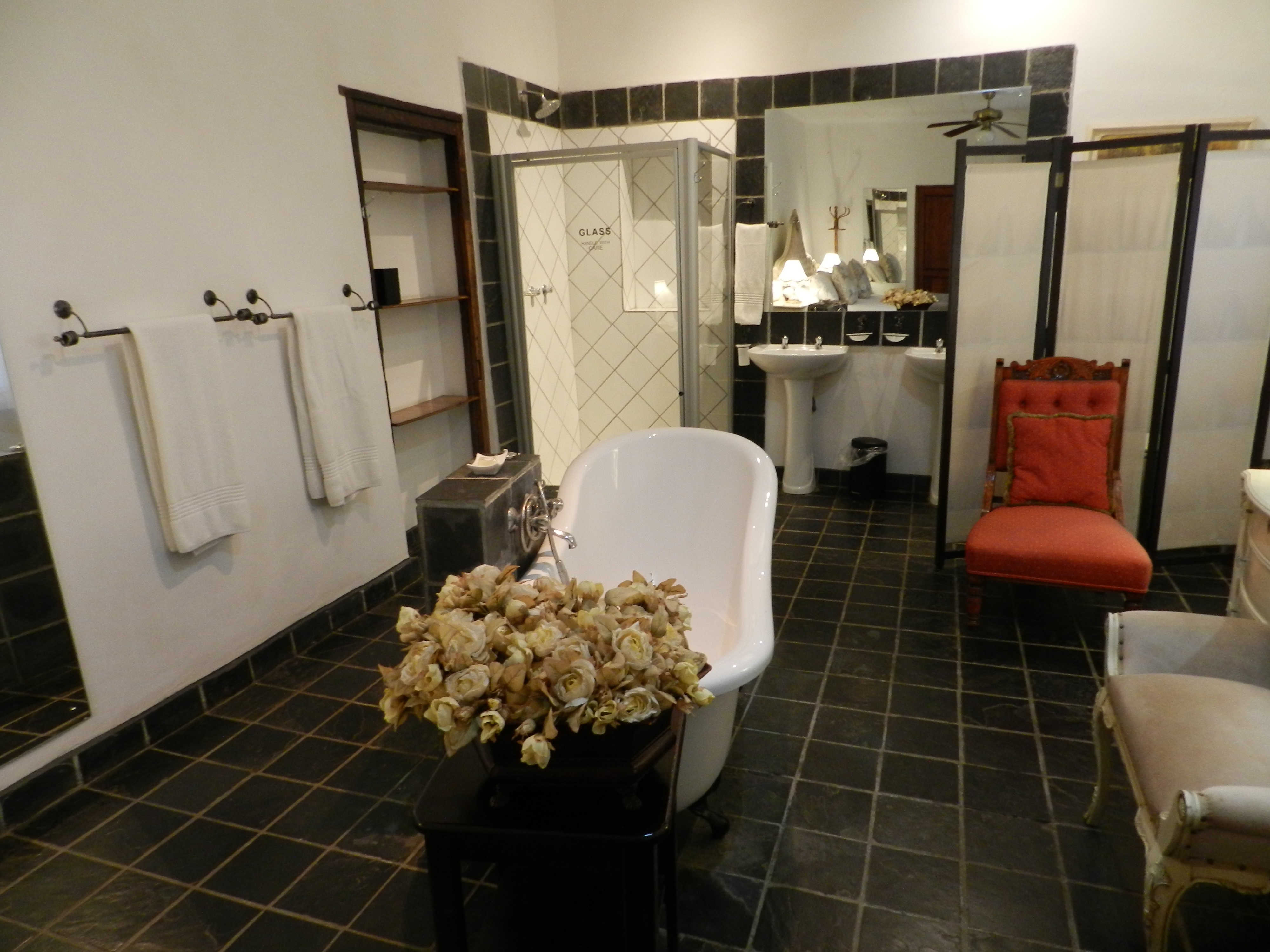 Bridal suite open bathroom with claw-foot bath and shower, towels provided, at the President Paul Kruger Guest Lodge