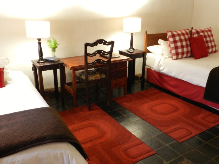 Gezina Room double and single beds and a working desk at the President Paul Kruger Guest Lodge