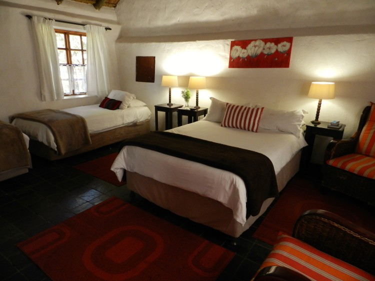 Susanna Room double and three-quarter beds with small sitting area at the President Paul Kruger Guest Lodge
